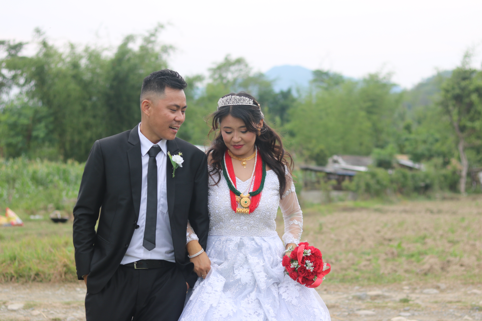 Bride and groom walking together outdoors after their wedding ceremony
